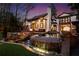 This luxurious backyard features a tiered stone pool, waterfall feature and hot tub for ultimate relaxation at 1352 Middlesex Ne Ave, Atlanta, GA 30306