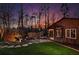 A picturesque backyard view shows a modern wooden shed and Zen garden nestled among mature trees and a manicured lawn at 1352 Middlesex Ne Ave, Atlanta, GA 30306