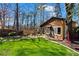 Lush backyard with a rustic guest house and a tree swing, perfect for outdoor enjoyment at 1352 Middlesex Ne Ave, Atlanta, GA 30306