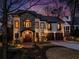 Stunning two-story home with stone and stucco facade, elegant balconies, and well-manicured landscaping at 1352 Middlesex Ne Ave, Atlanta, GA 30306