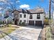 Beautiful two-story home with stone accents, a well-manicured lawn, and an expansive driveway at 1352 Middlesex Ne Ave, Atlanta, GA 30306