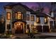 Elegant two-story home featuring stone accents, arched windows, and a well-lit entryway at 1352 Middlesex Ne Ave, Atlanta, GA 30306