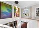 Bright foyer featuring hardwood floors, modern chandelier, and large paintings adding vibrant color at 1352 Middlesex Ne Ave, Atlanta, GA 30306