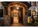 Grand entrance features a stone archway, custom wooden doors, and elegant lighting fixtures at 1352 Middlesex Ne Ave, Atlanta, GA 30306