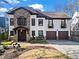Charming two-story home with stone accents, a well-manicured lawn, and a two-car garage at 1352 Middlesex Ne Ave, Atlanta, GA 30306