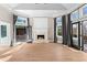 Elegant living room with an outdoor kitchen view, fireplace, and expansive windows at 1352 Middlesex Ne Ave, Atlanta, GA 30306