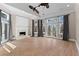 Bright living room with a fireplace, hardwood floors, and multiple doors to the exterior at 1352 Middlesex Ne Ave, Atlanta, GA 30306