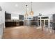 Open-concept living space with a bar area, wine fridge, hardwood flooring, and backyard access at 1352 Middlesex Ne Ave, Atlanta, GA 30306