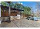 An outdoor kitchen with a built-in grill, sink, refrigerator, and stone counter space by the pool at 1352 Middlesex Ne Ave, Atlanta, GA 30306