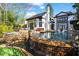 An exterior view of the pool with a stone waterfall feature, spa, and lush landscaping at 1352 Middlesex Ne Ave, Atlanta, GA 30306