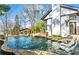 A luxurious pool with integrated loungers and lush landscaping, perfect for outdoor relaxation at 1352 Middlesex Ne Ave, Atlanta, GA 30306