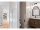 Hallway leading to powder room with marble countertop, patterned wood cabinet, and traditional mirror at 1352 Middlesex Ne Ave, Atlanta, GA 30306