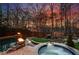 A luxurious pool and spa feature rock accents, waterfalls, and lush landscaping, creating an oasis-like backyard retreat at 1352 Middlesex Ne Ave, Atlanta, GA 30306