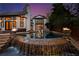 Backyard with a stunning waterfall feature flowing into a luxurious pool and spa area with custom fire bowls at 1352 Middlesex Ne Ave, Atlanta, GA 30306