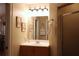 Well-lit bathroom features a single vanity, decorative mirror, and a shower with glass door at 4040 Merritt Dr, Cumming, GA 30041