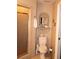 Cozy bathroom includes a toilet with a shelf and mirror above it, next to a glass door shower at 4040 Merritt Dr, Cumming, GA 30041