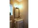 Close up of the vanity with a decorative mirror and a beige color scheme at 4040 Merritt Dr, Cumming, GA 30041