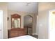 Bedroom featuring a wooden dresser with an arched doorway and a hallway at 4040 Merritt Dr, Cumming, GA 30041