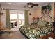 Relaxing bedroom featuring a king-sized bed, ceiling fan, and access to an outdoor balcony at 4040 Merritt Dr, Cumming, GA 30041