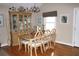 Elegant dining room boasts hardwood floors, a classic china cabinet, and seating for six, perfect for Gathering meals at 4040 Merritt Dr, Cumming, GA 30041