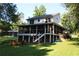Rear exterior of home with screened porch, deck, and well-manicured lawn and outdoor seating at 4040 Merritt Dr, Cumming, GA 30041