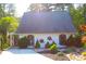 Beautiful exterior with rock landscaping, fish art, shutters, and meticulous yard maintenance at 4040 Merritt Dr, Cumming, GA 30041
