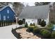 The property features a unique rock garden and appealing landscaping that enhances its curb appeal at 4040 Merritt Dr, Cumming, GA 30041