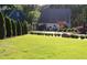 Charming home featuring a lush green lawn, mature landscaping, and a well-maintained exterior at 4040 Merritt Dr, Cumming, GA 30041