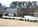 Charming white cottage with manicured landscaping and a spacious driveway, offering curb appeal at 4040 Merritt Dr, Cumming, GA 30041