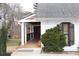 Inviting front porch with wood ceiling, security camera, with an American flag at 4040 Merritt Dr, Cumming, GA 30041