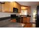 Modern kitchen featuring light-colored cabinets, granite countertops, and stainless steel appliances at 4040 Merritt Dr, Cumming, GA 30041