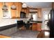 Updated kitchen with light wood cabinets, black appliances, granite countertops, and hardwood flooring at 4040 Merritt Dr, Cumming, GA 30041