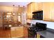 Well-lit kitchen features gas range, stainless steel microwave and open view to dining room at 4040 Merritt Dr, Cumming, GA 30041