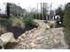 The property features a beautiful rock garden and appealing stone pathway with lush landscaping at 4040 Merritt Dr, Cumming, GA 30041
