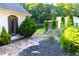Artistic landscaping with a stone path and river rock drainage in a well-maintained yard at 4040 Merritt Dr, Cumming, GA 30041