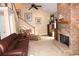 Inviting living room with stone fireplace, comfortable seating, and ample natural light creating an ideal space for relaxation at 4040 Merritt Dr, Cumming, GA 30041