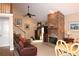 Cozy living room showcases a stone fireplace, leather furniture, and a vaulted ceiling, creating a warm atmosphere at 4040 Merritt Dr, Cumming, GA 30041