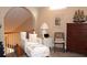 Comfortable loft space with an upholstered chair and a large ship decoration on top of a wooden dresser at 4040 Merritt Dr, Cumming, GA 30041