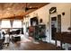 Covered patio with a wood ceiling, ceiling fans, fireplace, seating, and view of the backyard at 4040 Merritt Dr, Cumming, GA 30041