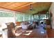 Expansive screened porch featuring a grill, comfortable seating, and wooded views at 4040 Merritt Dr, Cumming, GA 30041