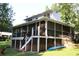 View of screened porch with deck and stairs leading to backyard at 4040 Merritt Dr, Cumming, GA 30041