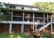 Close-up of screened porch with access to a deck and lattice-enclosed storage area at 4040 Merritt Dr, Cumming, GA 30041