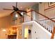 Open staircase features white spindles, and wood railing and provides access to the second floor at 4040 Merritt Dr, Cumming, GA 30041