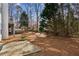 Expansive backyard featuring a patio, lush greenery, and mature trees, ideal for outdoor living and entertainment at 1283 Hada Ct, Lawrenceville, GA 30043