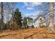 A house's spacious backyard featuring a well-manicured lawn, framed by lush trees and a private fence at 1283 Hada Ct, Lawrenceville, GA 30043