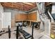 Unfinished basement with exposed ceiling, a work bench, and gym equipment at 1283 Hada Ct, Lawrenceville, GA 30043