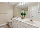 Bathroom with double vanity, drawers, large mirror, and tiled floor with toilet and closed door at 1283 Hada Ct, Lawrenceville, GA 30043