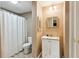 Well-lit bathroom featuring a shower-tub combination and a framed mirror at 1283 Hada Ct, Lawrenceville, GA 30043