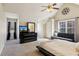 Spacious bedroom featuring neutral walls, plush carpet, futon, ceiling fan, and natural light from two windows at 1283 Hada Ct, Lawrenceville, GA 30043