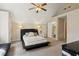 Bedroom with neutral walls, an ensuite bathroom, a ceiling fan and carpet flooring at 1283 Hada Ct, Lawrenceville, GA 30043